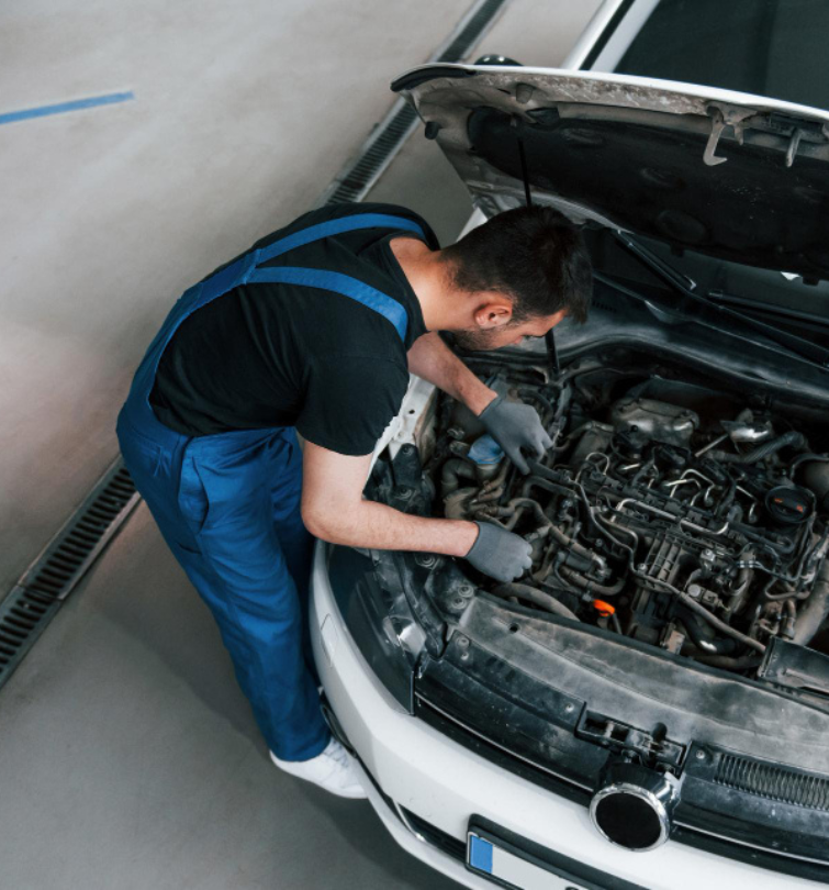 Mechanic servicing vehicle - NEW DMK AUTO SERVICES